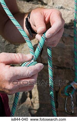 Rock climber knotting rope View Large Photo Image Stock Image - Rock climber knotting rope. Fotosearch