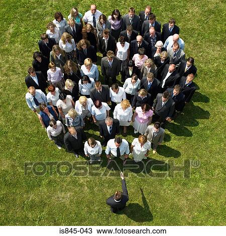 Businessman facing crowd View Large Photo Image Stock Image - Businessman facing crowd. Fotosearch