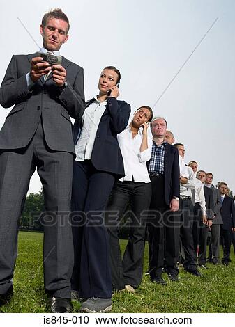 Stock Image - Businesspeople in a queue. Fotosearch