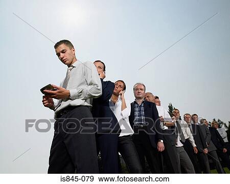 Businesspeople waiting in a queue View Large Photo Image Stock Photo - Businesspeople waiting in a queue. Fotosearch