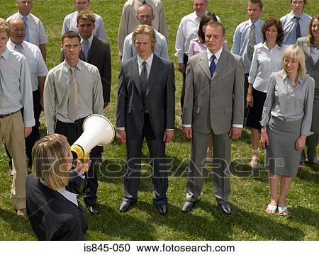 Stock Image - Businesswoman talking to colleagues. Fotosearch