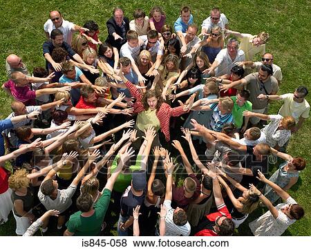 Man in the middle of a crowd View Large Photo Image Stock Photo - Man in the middle of a crowd. Fotosearch