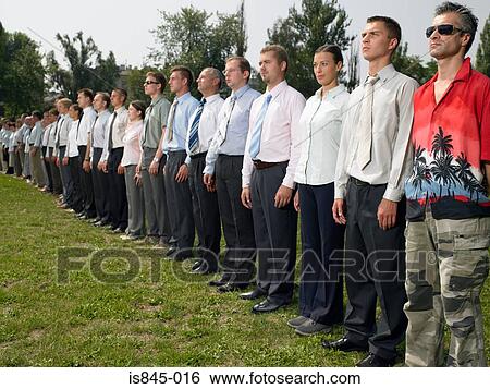 Stock Photograph - Man standing out from the crowd. Fotosearch