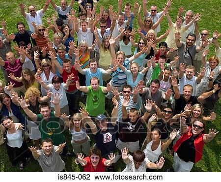 Stock Image - People in a crowd with arms raised. Fotosearch
