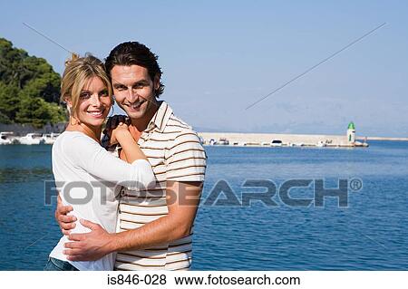 Couple hugging by a harbour View Large Photo Image Stock Photo - Couple hugging by a harbour. Fotosearch