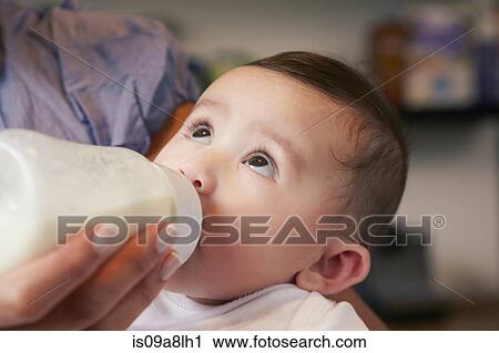 Baby girl drinking bottle of milk View Large Photo Image Stock Image - Baby girl drinking bottle of milk. Fotosearch