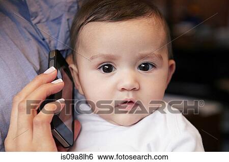 Baby girl listening to cell phone View Large Photo Image Stock Photograph - Baby girl listening to cell phone. Fotosearch