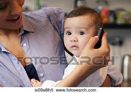Baby girl listening to cell phone View Large Photo Image Stock Photography - Baby girl listening to cell phone. Fotosearch