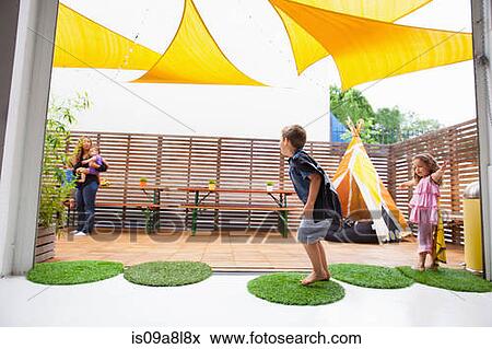 Stock Photo - Children playing on patio. Fotosearch