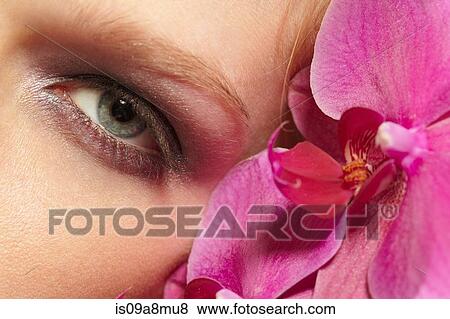Close up of female face and orchids View Large Photo Image Stock Photo - Close up of female face and orchids. Fotosearch