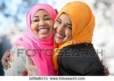 Close up portrait of two young woman in park View Large Photo Image Picture - Close up portrait of two young woman in park. Fotosearch