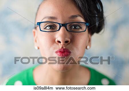 Close up portrait of woman puckering her lips View Large Photo Image Picture - Close up portrait of woman puckering her lips. Fotosearch