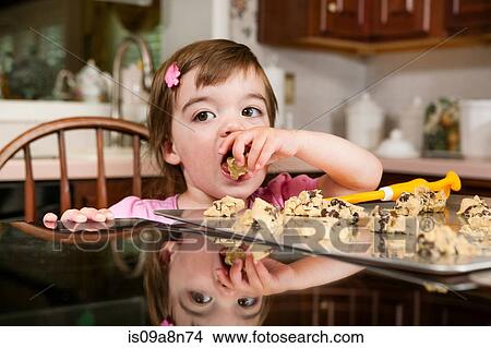 Close up portrait of young female toddler eating currant cakes View Large Photo Image Picture - Close up portrait of young female toddler eating currant cakes. Fotosearch