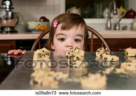 Close up portrait of young female toddler looking at currant cakes View Large Photo Image Stock Image - Close up portrait of young female toddler looking at currant cakes. Fotosearch