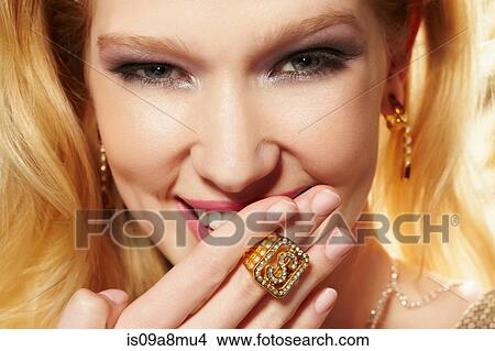 Close up portrait of young woman wearing diamond signet ring View Large Photo Image Picture - Close up portrait of young woman wearing diamond signet ring. Fotosearch