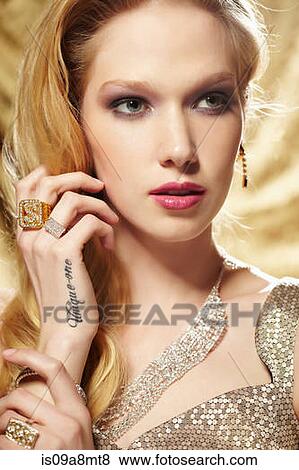 Close up portrait of young woman with hand tattoo View Large Photo Image Stock Photo - Close up portrait of young woman with hand tattoo. Fotosearch