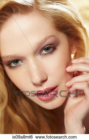 Stock Photograph - Close up studio portrait of young blond woman. Fotosearch