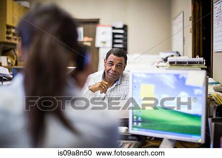 Colleagues working in office View Large Photo Image Stock Image - Colleagues working in office. Fotosearch
