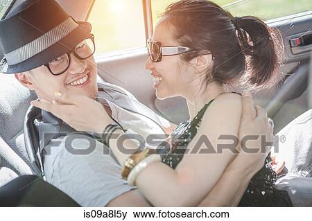 Stock Photo - Couple in car, smiling. Fotosearch