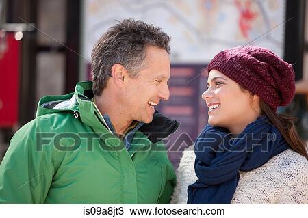 Stock Image - Couple in warm clothing smiling. Fotosearch
