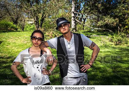Stock Image - Couple wearing sunglasses, portrait. Fotosearch