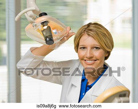 Dentist using dental camera in examining room, portrait View Large Photo Image Stock Image - Dentist using dental camera in examining room, portrait. Fotosearch