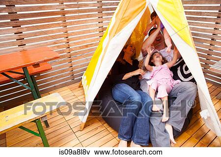 Stock Photo - Family playing in tent. Fotosearch