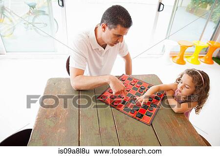 Father and daughter playing draughts View Large Photo Image Stock Photograph - Father and daughter playing draughts. Fotosearch