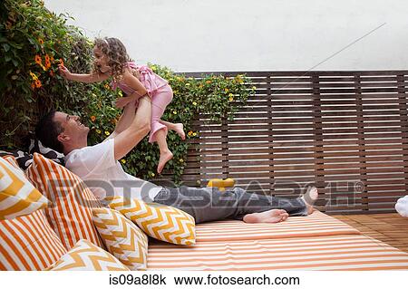 Father lifting daughter in the air View Large Photo Image Stock Image - Father lifting daughter in the air. Fotosearch