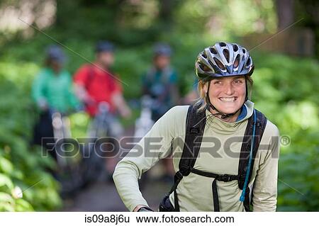 Female cyclist smiling View Large Photo Image Stock Photograph - Female cyclist smiling. Fotosearch