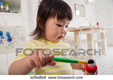 Female toddler holding paintbrush and paint View Large Photo Image Stock Photo - Female toddler holding paintbrush and paint. Fotosearch