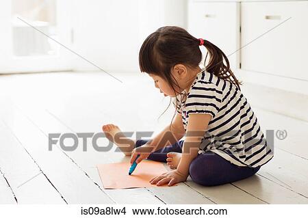 Picture - Female toddler sitting on floor drawing. Fotosearch