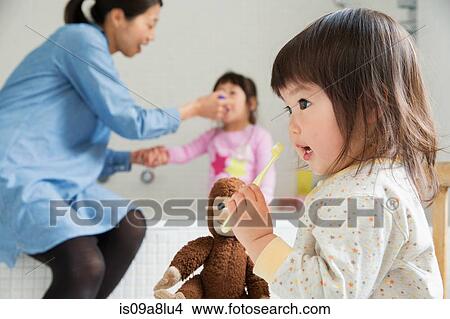 Female toddler with cuddly toy and toothbrush View Large Photo Image Picture - Female toddler with cuddly toy and toothbrush. Fotosearch