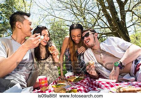 Four friends having picnic View Large Photo Image Stock Image - Four friends having picnic. Fotosearch