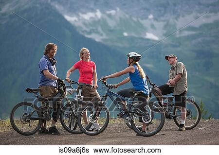Stock Photograph - Four friends mountain biking together. Fotosearch