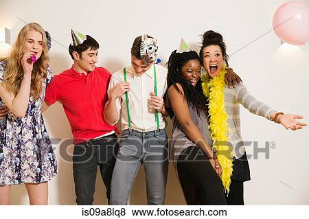 Friends at a party with balloons, studio shot View Large Photo Image Stock Photo - Friends at a party with balloons, studio shot. Fotosearch