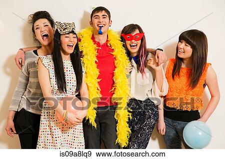 Friends at a party with balloons, studio shot View Large Photo Image Stock Photo - Friends at a party with balloons, studio shot. Fotosearch