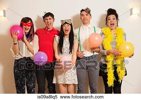 Friends at a party with balloons, studio shot View Large Photo Image Stock Photography - Friends at a party with balloons, studio shot. Fotosearch