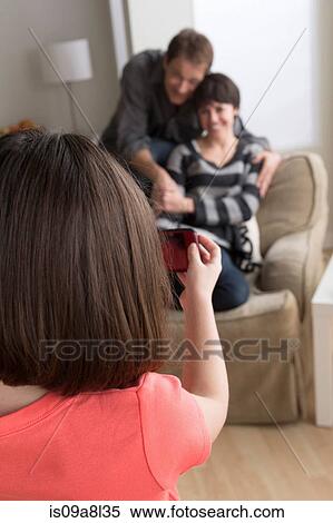 Girl taking photograph of parents with camera phone View Large Photo Image Stock Photography - Girl taking photograph of parents with camera phone. Fotosearch