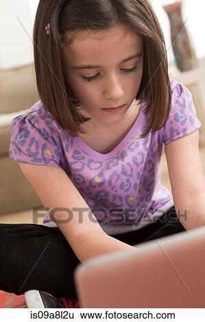Stock Photograph - Girl using laptop. Fotosearch