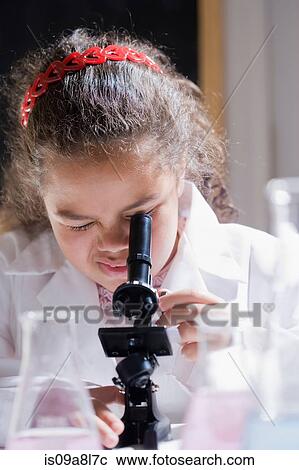 Stock Image - Girl using microscope. Fotosearch