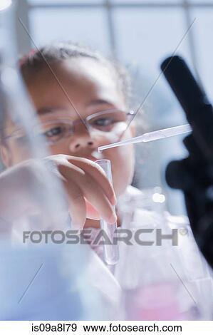 Girl using pipette View Large Photo Image Stock Photo - Girl using pipette. Fotosearch