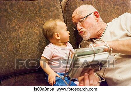 Grandfather and baby granddaughter on sofa View Large Photo Image Stock Image - Grandfather and baby granddaughter on sofa. Fotosearch