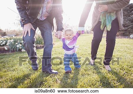 Grandparents walking granddaughter in garden View Large Photo Image Stock Image - Grandparents walking granddaughter in garden. Fotosearch
