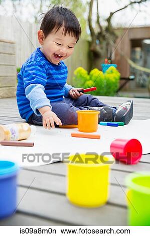 Male toddler drawing in garden View Large Photo Image Picture - Male toddler drawing in garden. Fotosearch
