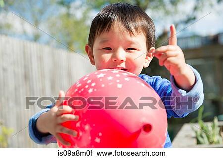 Male toddler in garden with red balloon View Large Photo Image Stock Image - Male toddler in garden with red balloon. Fotosearch