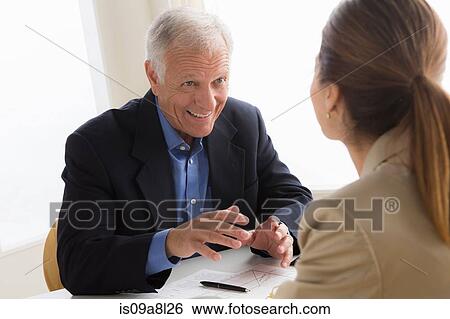 Man and woman talking in meeting View Large Photo Image Stock Photograph - Man and woman talking in meeting. Fotosearch