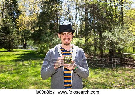 Man holding mug in garden View Large Photo Image Stock Photo - Man holding mug in garden. Fotosearch