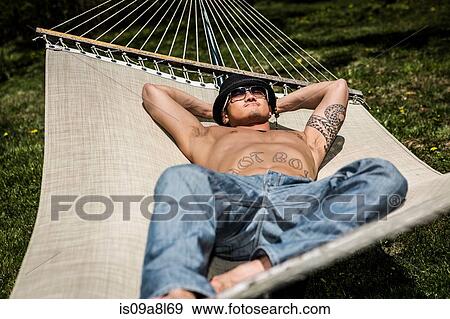 Man lying in hammock View Large Photo Image Stock Photo - Man lying in hammock. Fotosearch