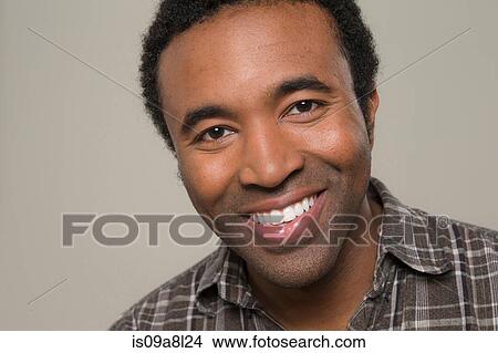 Picture - Man wearing brown checked shirt, portrait. Fotosearch